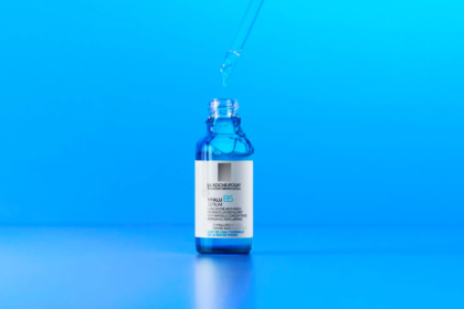 Närbild på La Roche-Posay Hyalu B5 Serum i blå glasflaska med pipett mot en klarblå bakgrund.